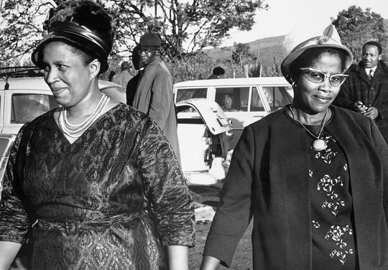 DANIEL 'KGOMO ' MOROLONG, WOMEN #103<br />
<br />
Mrs. F. M. Matikinca, a wife of the proprietor of a new trading station at Ngewazi,<br />
Middledrift, looks proudly around the site after the station had been officially opened last<br />
week. With her is Mrs. G. M. Matikinca
c 1950s - 1970s, Photographic Print